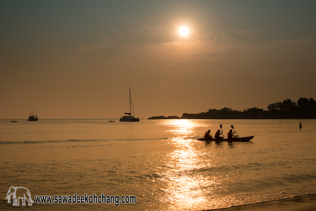 Kayaking with friends at sunset